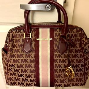 Dark Purple Michael Kors Satchel purse with a big stripe in the front of the bag